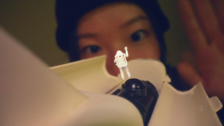 Andr waves at a miniature astronaut in the music video for Moon River (221007)