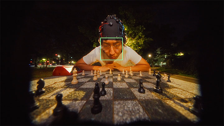 Kaz Moon plays chess while weaing an EEG headset in 百合花 Lilium's 萬事美妙 (Everything Will Go Wonderfully) music video